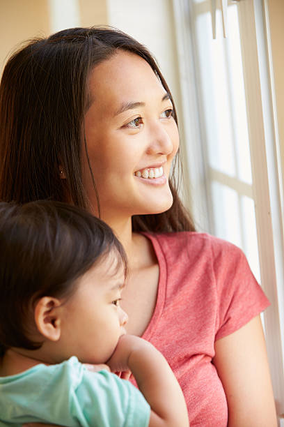 istock Mother Cuddling Young Son And Looking Out Of Window 514587713