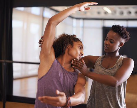 Shot of two young people practicing in a dance studio