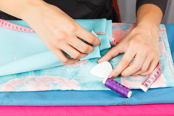 istock hands of a seamstress at work. 514611819