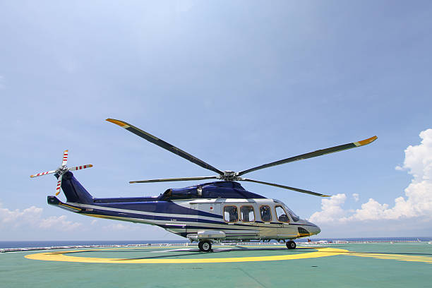 istock helicopter parking landing on offshore platform 514613059