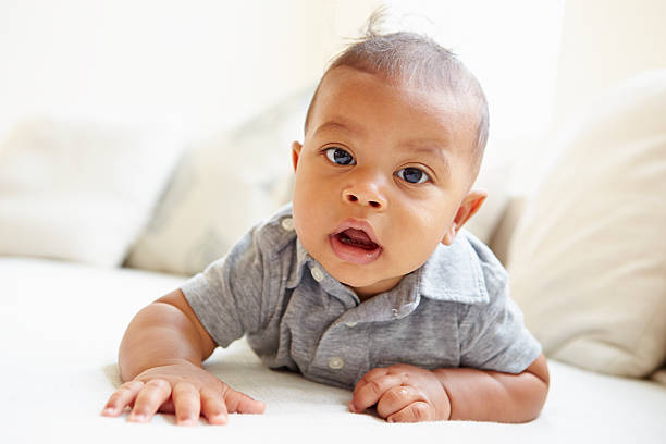 istock Smiling Baby Boy Lying On Tummy At Home 514614147