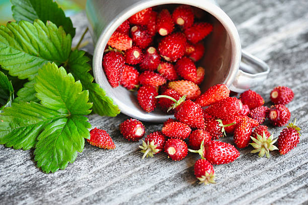 istock Fresh wild strawberries on an old wooden table 514617874