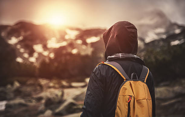 istock Traveler with backpack walking in mountains at sunset 514619548