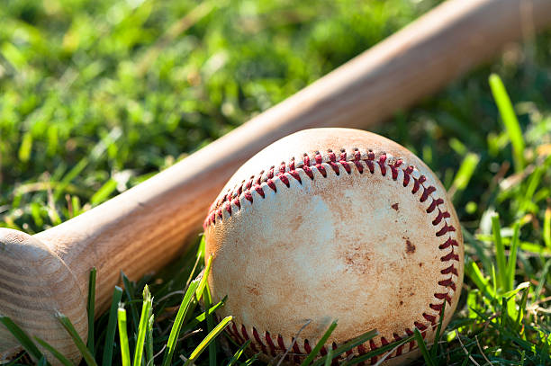 istock Baseball Bat and Ball on Grass Field 514619672