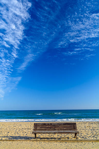 istock Wooden bench on the sandy beach landscape 514621826