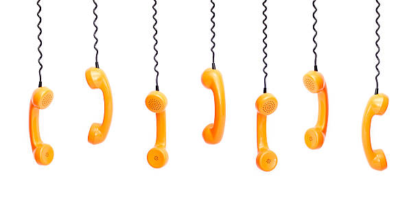 istock Handset piece from an old phone suspended by phone cord 514623174