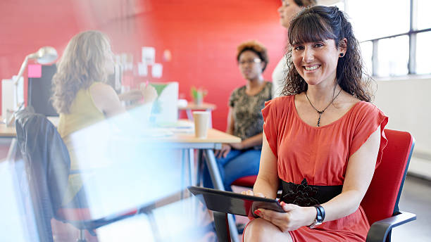 istock Confident female designer working on a digital tablet in red 514623442
