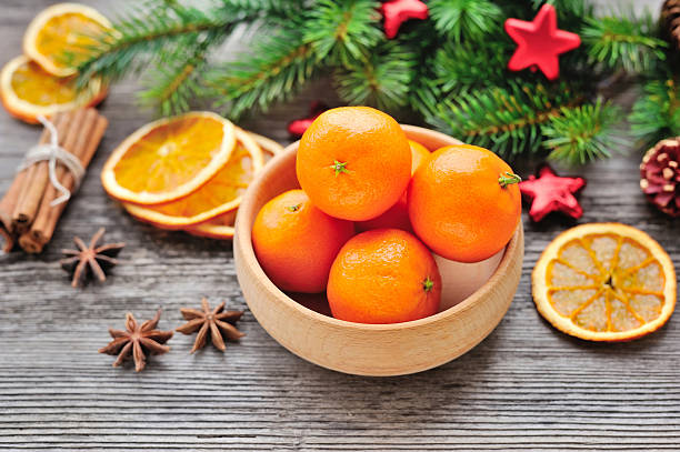 istock Tangerines and Christmas tree branches on a wooden table 514626250