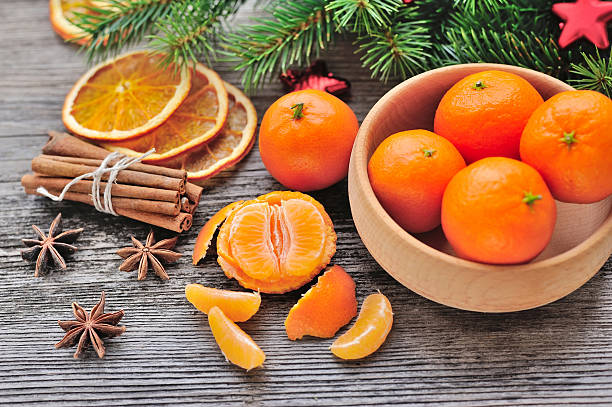 istock Tangerines and Christmas tree branches on a wooden table. Natura 514626276