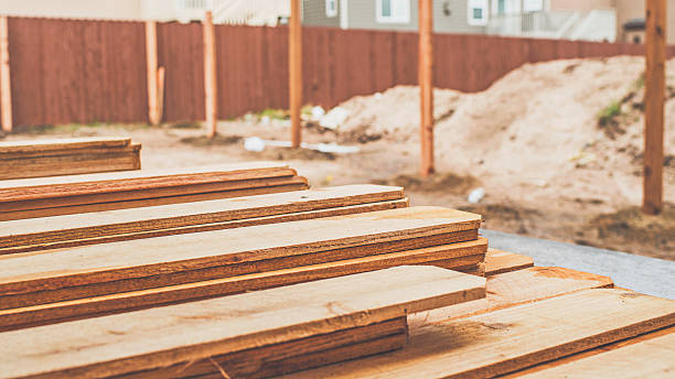 istock Fence planks on concrete patio ready for fence construction 514627480