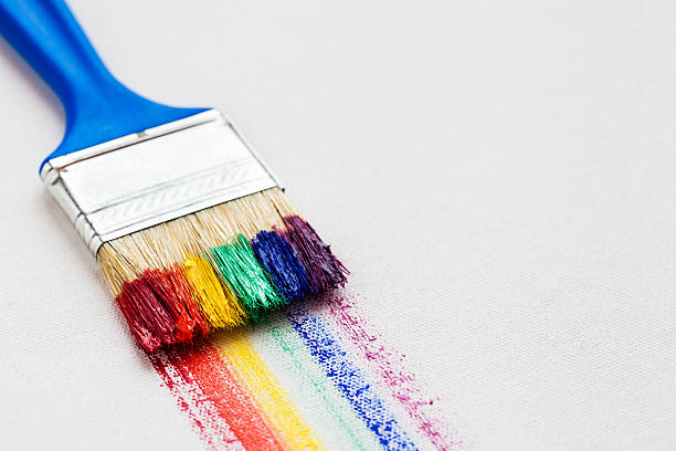 istock Paintbrush and multicolor rainbow brush strokes on white canvas 514627612