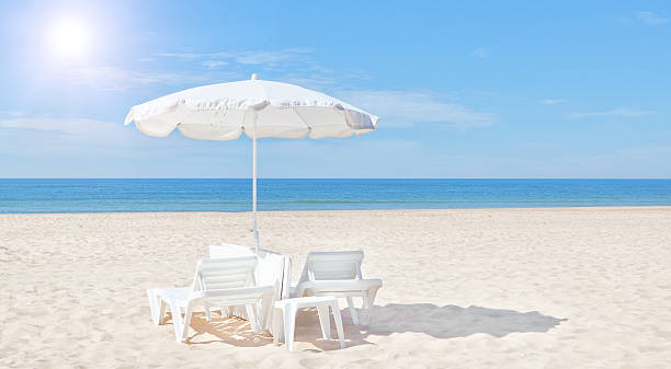 istock Beautiful white beach umbrella and sun bed on the beach. 514627772