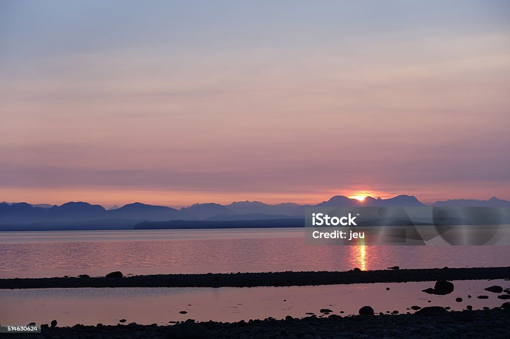 sunrise Picture of sunrise in July, taken from a beach on Quadra Island, BC, Canada. Beach Stock Photo