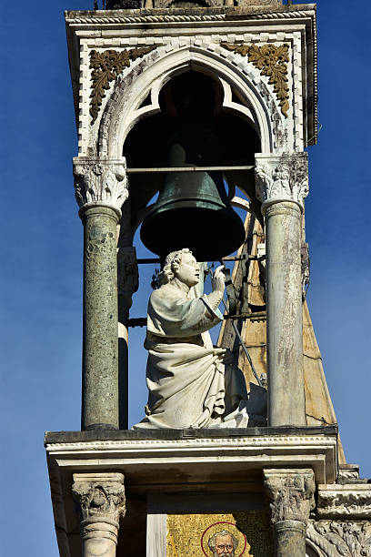 Detail of Saint Mark Basilica in Venice with beautiful medieval statue of a blessing saint in a small gothic belfry