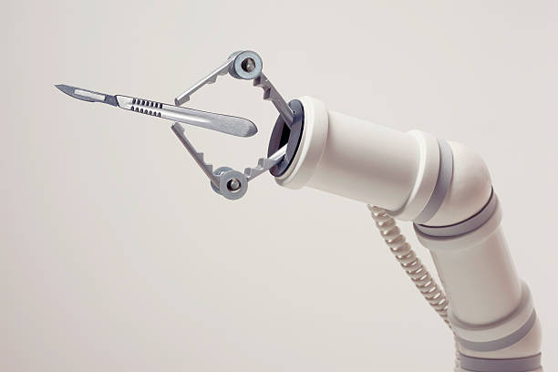 Medical Robotics Robotic arm with scalpel. scalpel photos stock pictures, royalty-free photos & images
