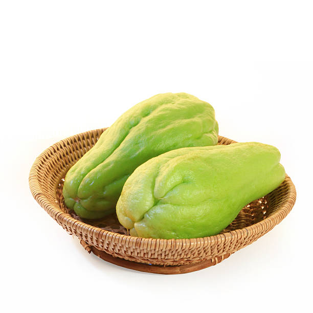 chayote squash, also known as choko chayote squash, also known as choko in basket on white. Christophine stock pictures, royalty-free photos & images