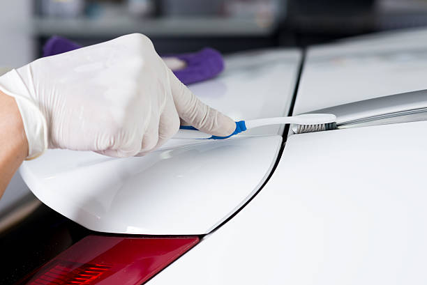 istock Car detailing series : Worker cleaning white car 514632666