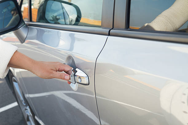 istock woman opens car door close up 514633211