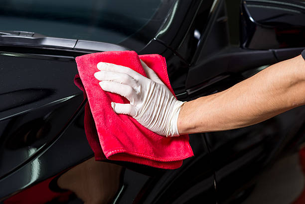 istock Car detailing series : Worker cleaning black car 514633278