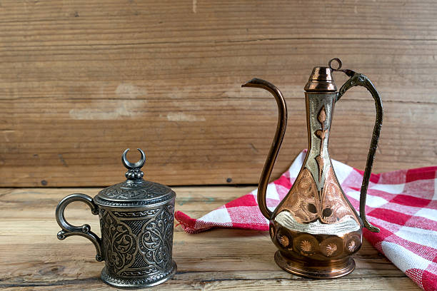 istock Turkish teapot with arabic decoration with metal cup 514633478