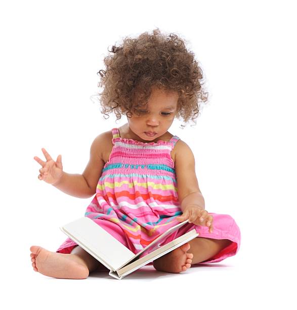 magnifique biracial bébé fille lisant un livre isolé sur blanc - baby book toddler reading photos et images de collection
