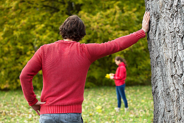 istock Man observing his girlfriend in park 514635433