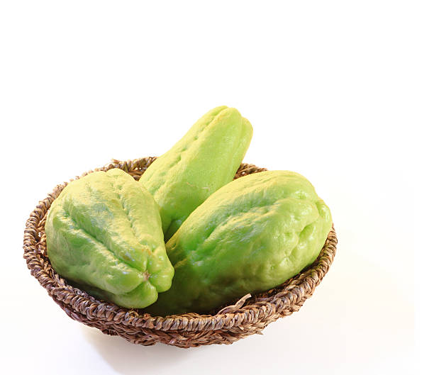 chayote squash, also known as choko chayote squash, also known as choko in basket on white Christophine stock pictures, royalty-free photos & images