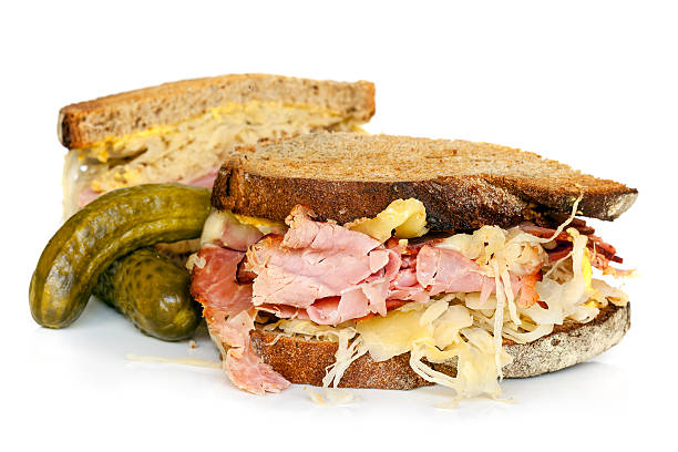 Reuben Sandwich Isolated on White Reuben sandwich isolated on white, with dill pickles. pastrami photos stock pictures, royalty-free photos & images