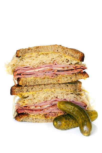Reuben Sandwich Isolated on White Reuben sandwich isolated on white, with dill pickles. pastrami stock pictures, royalty-free photos & images