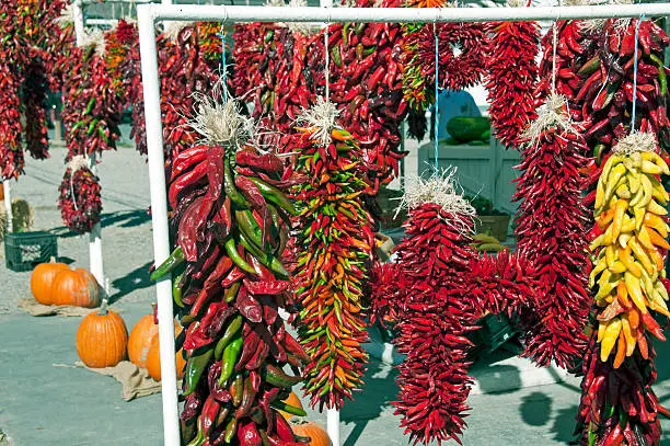 Chili pepper ristras and pumpkins at farmers' market in fall in New Mexico