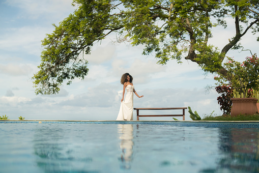 Beautiful bride posing in front of the pool