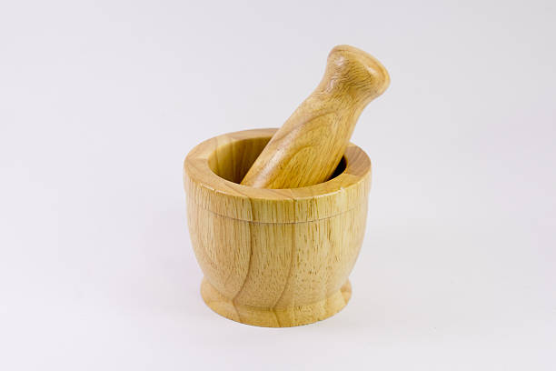 istock Handmade small wooden mortar on white background- 514638910