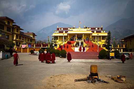McLeod Ganj, India - January 27, 2016: Tibetan Buddhist monks with a ceremonial fire filled with hot oil at the temple of Gyuto monastery, Dharamshala, India