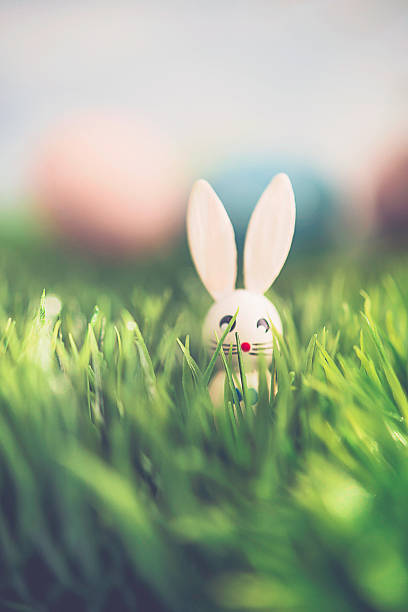 istock Easter arrangement with decorated eggs and vintage wood bunny 514640944