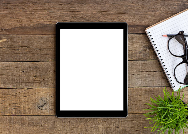 istock digital tablet on wood table blank space for adjustment 514642168