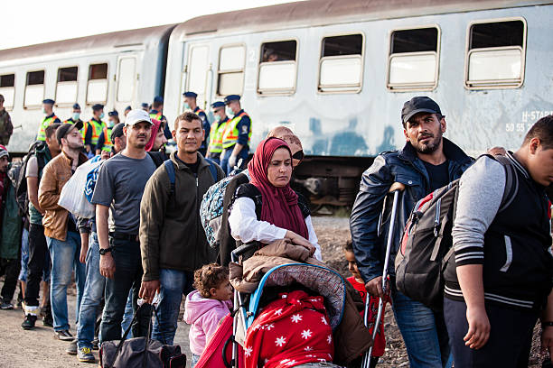 War refugees at Zakany Railway Station Zakany, Hungary - October 5, 2015: War refugees at Zakany Railway Station, Refugees are arriving constantly to Hungary on the way to Germany. 5 Octoberber 2015 in Zakany, Hungary. islamic state stock pictures, royalty-free photos & images