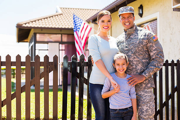 american soldier reunited with family happy american soldier reunited with family outside their home veteran military army armed forces stock pictures, royalty-free photos & images