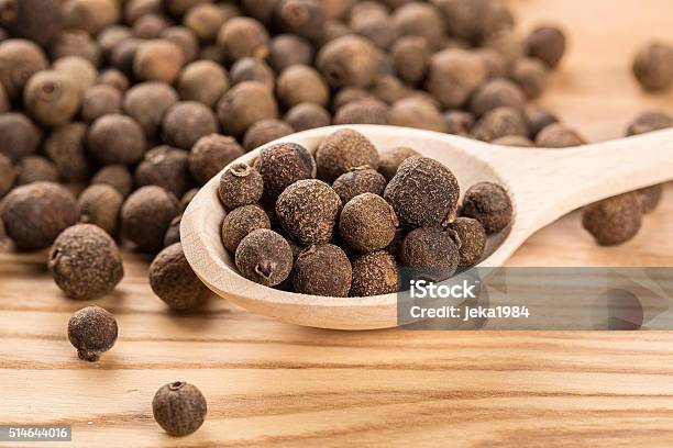 Allspice In A Wooden Spoon On The Wood Table Stock Photo - Download Image Now - Allspice, Aromatherapy, Berry