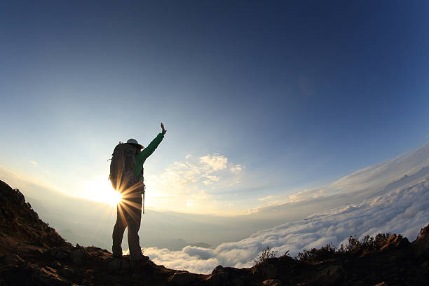 istock silhouette of backpacker hiking on sunset mountain peak 514645346