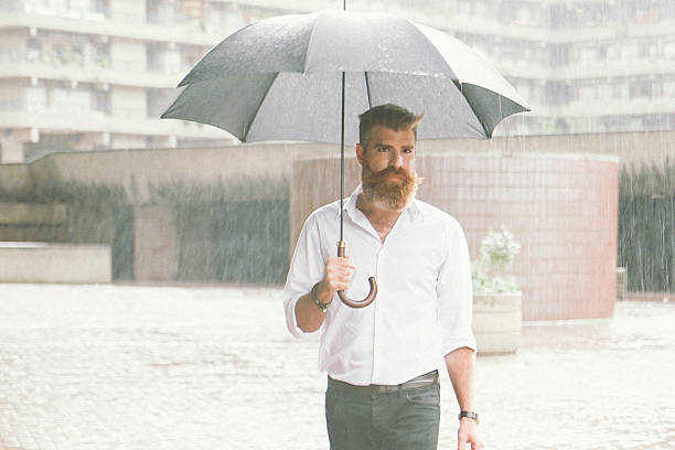 istock Businessman With Umbrella In The Rain 514646278