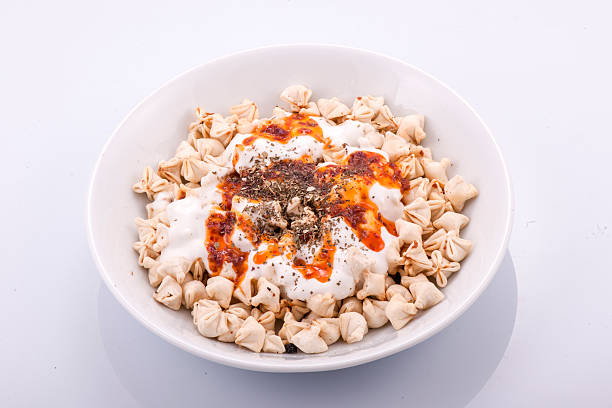 istock Turkish Manti on plate with red pepper, tomatoes sauce, yogurt 514646638