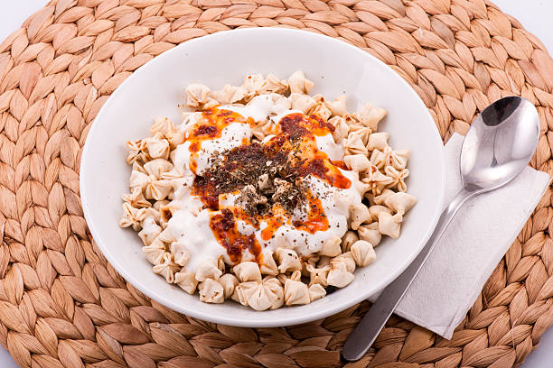istock Turkish Manti on plate with red pepper, tomatoes sauce, yogurt 514647554