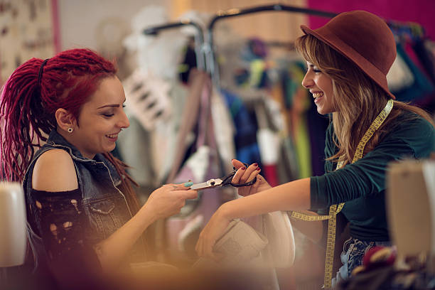 istock Playful fashion designers having fun with scissors in a studio. 514647856