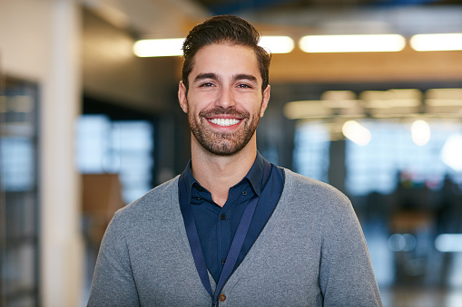 Cropped portrait of a young man standing in the office