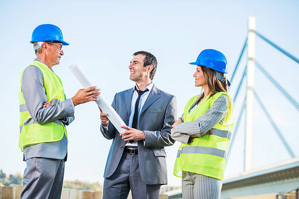 istock Two architects with businessman outdoors. 514651263