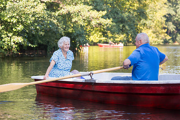 istock Happy senior couple rowing a boat on lake 514653517