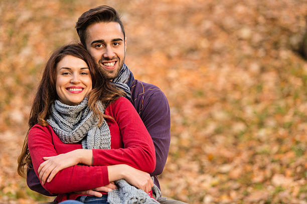 istock Young couple hugging in park 514654545