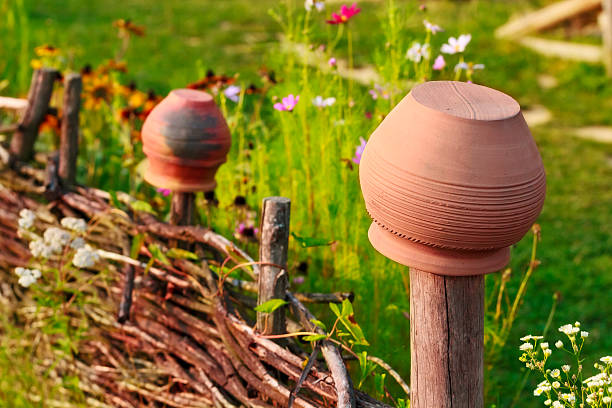 Summer scene with clay pot and an old wooden fence