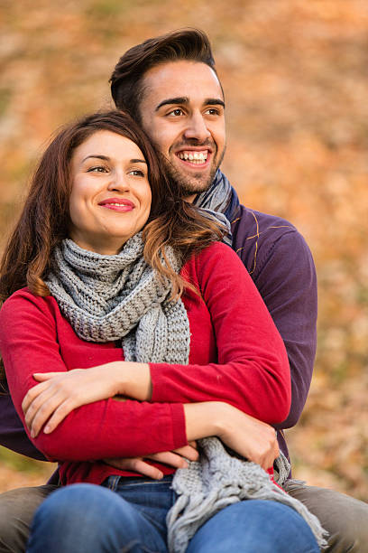 istock Young couple hugging in park 514654569