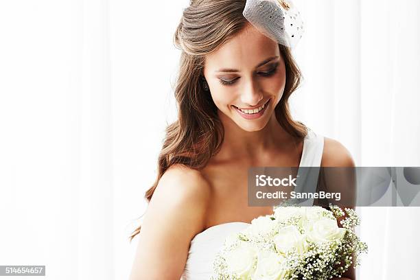 Young Bride In Wedding Dress Holding Bouquet Studio Shot Stock Photo - Download Image Now